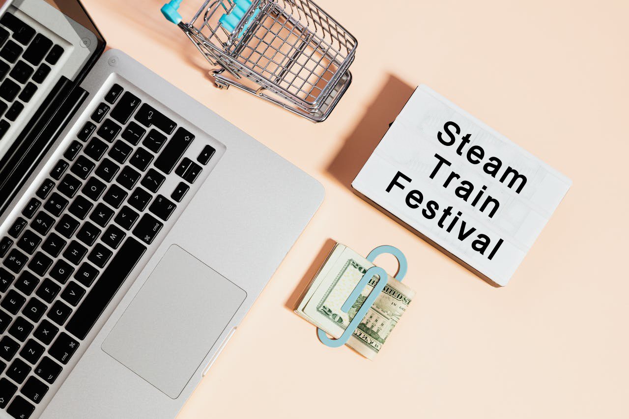 Plaatje met laptop en winkelwagen met als tekst: Steam Train Festival.